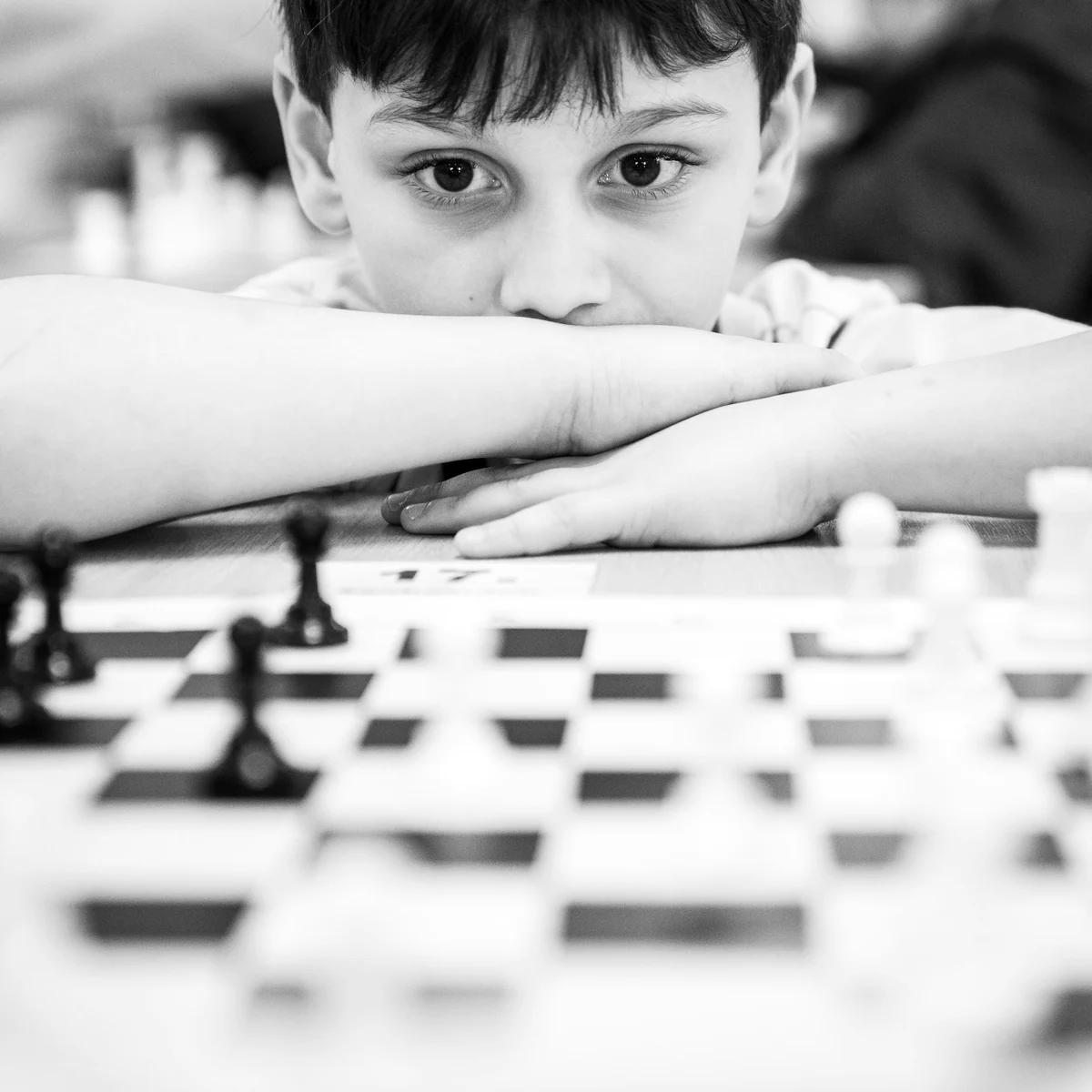 A student studying a chess position close to the board